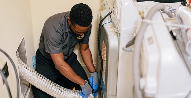 Tech working on dryer vent repair.